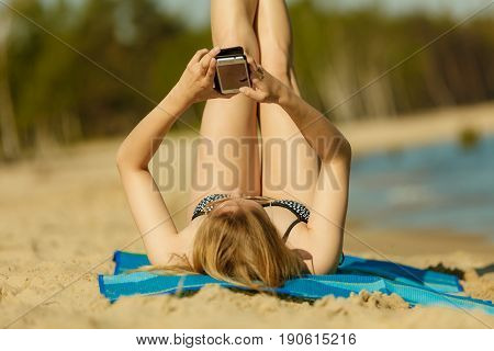 Woman In Bikini Sunbathing And Relaxing On Beach