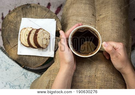 Palms Warming Cup Of Hot Coffee. Man Holding A Cup Of Coffee And Piece Of Cake.