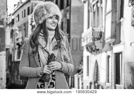 Smiling Young Woman In Venice, Italy In Winter Looking Aside