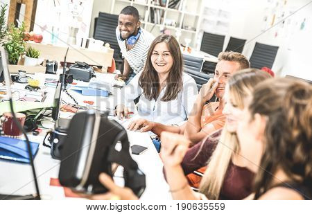Group of young people employee workers having fun with vr virtual reality goggles in urban alternative studio - Business concept of human resource on working time - Start up entrepreneurs at office