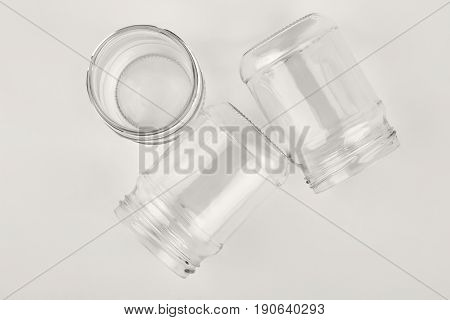 Closeup glassware containers, white background. Group of flass vessels.