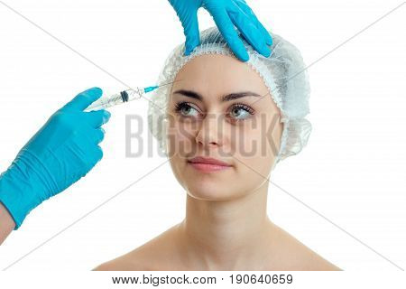 the woman on the procedure at the plastic surgeon isolated on white background