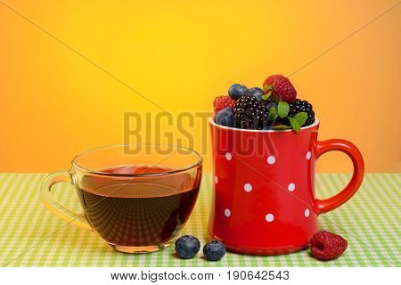 Cup with scuttered berries on the table