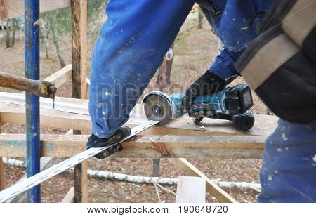 KIEV - UKRAINE JUNE - 19 2017: Contractor Cutting Soffits Board. Roofing Repair. Fascia and Soffit Repair.