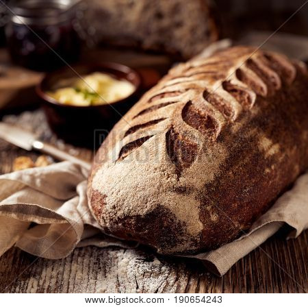 Rustic sourdough spelled bread on wooden table