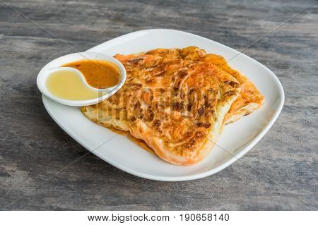 Indian Roti Prata With Condensed Milk And Curry Sauce