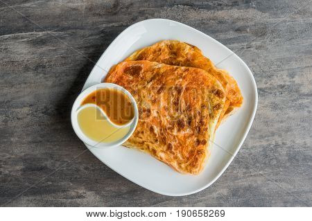 Indian Roti Prata With Condensed Milk And Curry Sauce