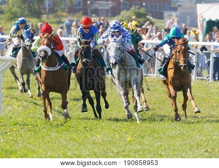 STOCKHOLM SWEDEN - JUNE 06 2017: Jockeys on gallop arabian race horses storming ahead at Nationaldags Galoppen at Gardet. June 6 2017 in Stockholm Sweden