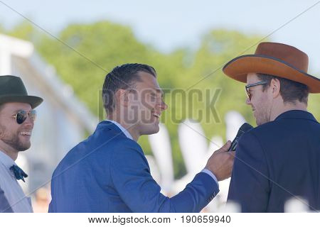 STOCKHOLM SWEDEN - JUNE 06 2017: Presenter Per Skoglund interview people on stage at Nationaldags Galoppen at Gardet. June 6 2017 in Stockholm Sweden