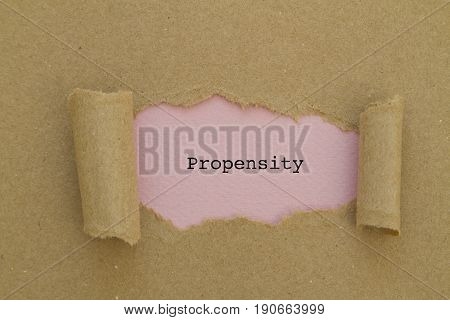 PROPENSITY word written under torn paper .