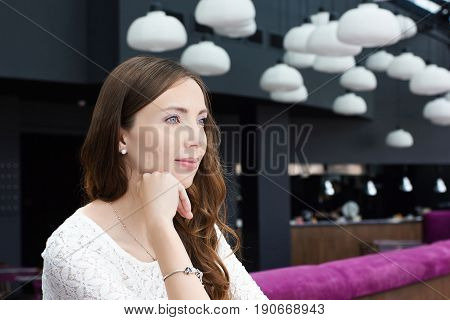 Young woman listens attentively to her interlocutor.