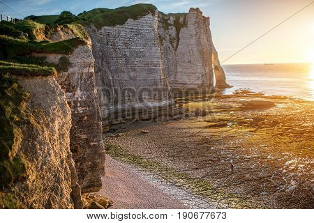 Landscape view on the rocky coastline near Etretat town in France during the sunset