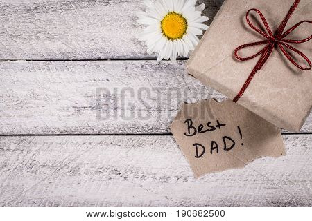 Father's day holiday.  greeting card. present gift box on wooden background