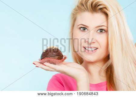 Woman Holding Chocolate Cupcake About To Bite