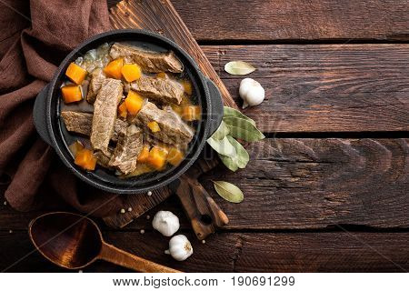 Delicious braised beef meat in broth with vegetables goulash