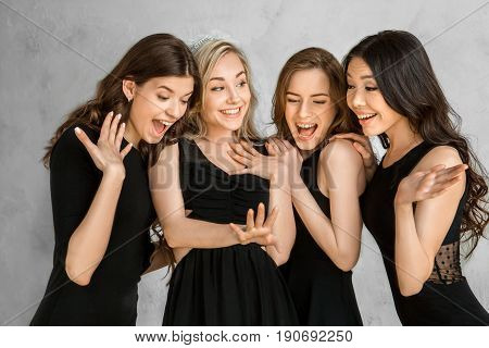 Young female friends together celebration white background showing ring