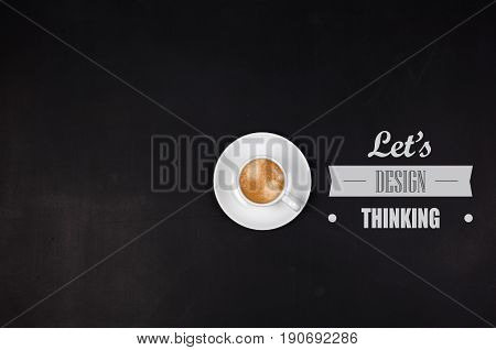 Designthinking concept. Cup of coffee on blackboard. Copyspase in left side.