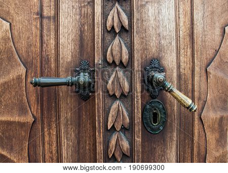 Old wooden door with iron handle on the Prešeren square in Ljubljana, Slovenia - Jun 2017