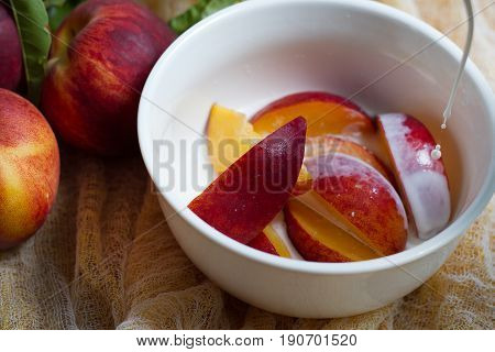 fresh local peaches with cream pouring on them