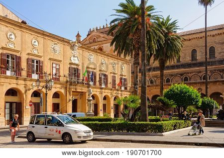 A taxi is waiting for passengers in front of the Town Hall and Cathedral on the Vittorio Emanuele Square - Monreale, Sicily, Italy, 21 October 2011