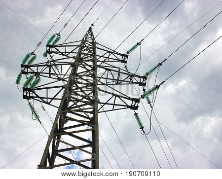 Transmission power tower electricity pylon over blue sky. Steel lattice tower used to support an overhead power line