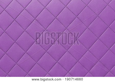 detail of sewn leather purple leather upholstery background pattern