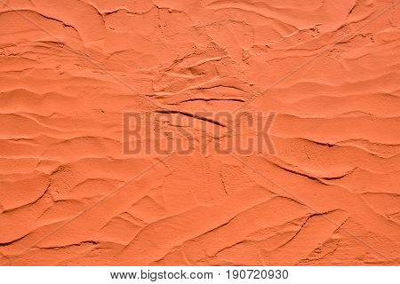 Orange color plaster wall texture as background