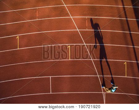 Shot of a young male athlete training on a race track. Sprinter running on athletics tracks.