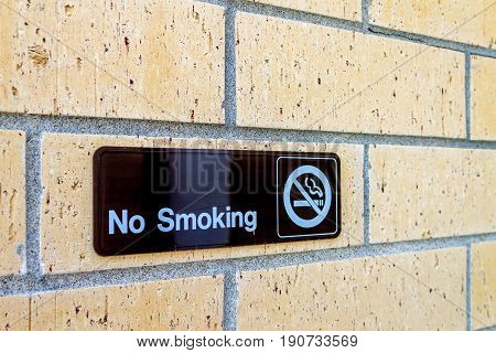 No smoking sign on a brick wall