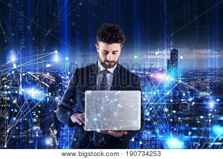 Man working on a laptop. Concept of programming and software analysis