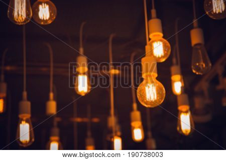 blur hang light blub interior cafe lighting for background.