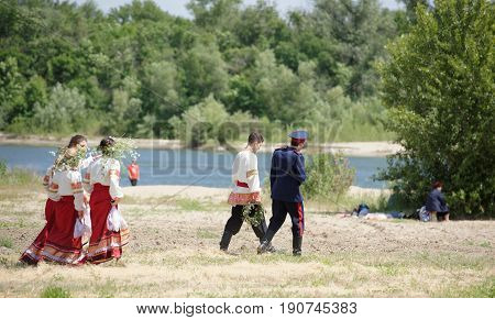 RazdorskayaRostov Region Russia- June 04; 2017:Cossack youth goes to throw wreaths in the river Don to the Trinity