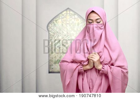 Portrait Of Asian Muslim Woman Wearing Niqab Praying