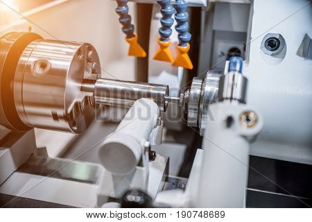 Intragrinding machine during operation. There grinding inner sleeve hole. The effect of sunlight