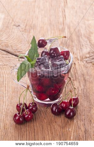 Ice cream and cherry juice on wooden background
