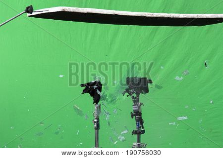 Implosion of a glass of an car on a background of a green sheet for a scene of an action movie