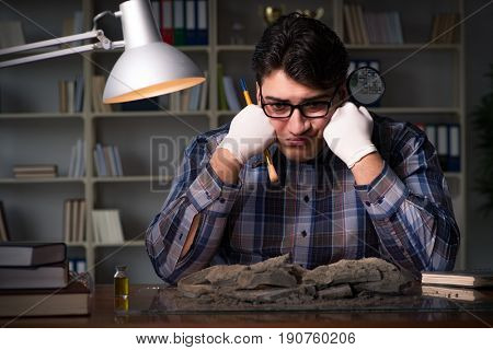 Archeologist working late night in office