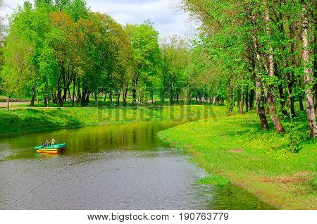 VITEBSK BELARUS - MAY 21 2017: Unknown people ride on catamaran on Vitba river in park of culture and rest named after Frunze Vitebsk Belarus