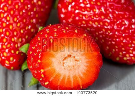 Sweet garden strawberry with cut close up macro