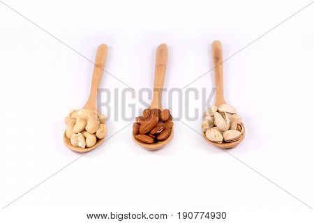 Delicious almond nuts,cashew and pistachio in wooden spoon  on white background.