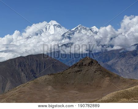 Snow capped mountain Dhaulagiri from Muktinath's desert - Annapurna Circuit trek in Nepal