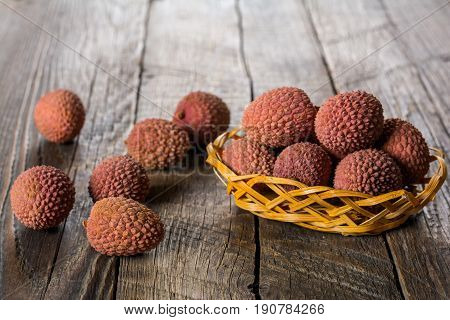 Lychees exotic fruits on a wooden background