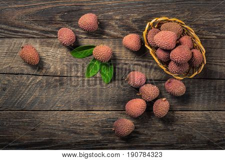 Lychees exotic fruits on a wooden background