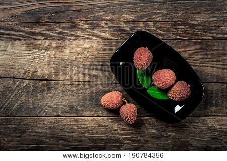 Lychees exotic fruits on a wooden background