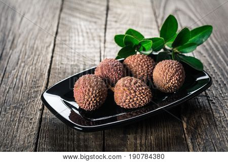 Lychees exotic fruits on a wooden background