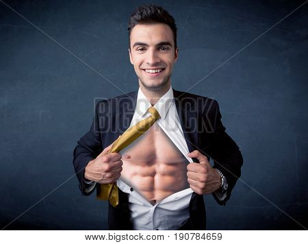 Businessman tearing off his shirt and showing mucular body concept on background