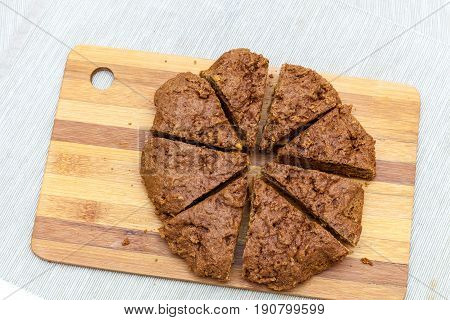 Cut apricot pie with slices on a cutting board