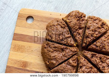 Cut apricot pie with slices on a cutting board