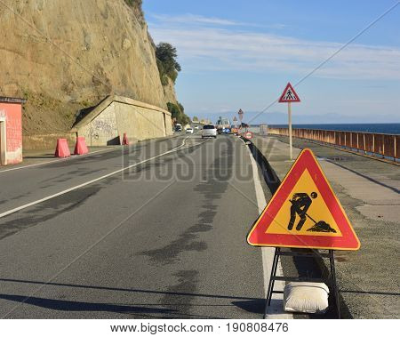 Road signs to warn motorists and pedestrians to pay attention to road works