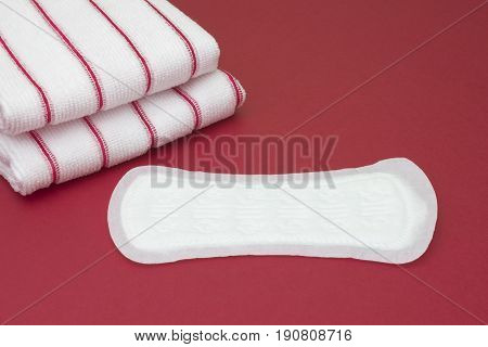 Striped terry towels and daily menstrual woman pad for blood period. Menstruation sanitary soft pads hygiene protection. Woman critical days gynecological menstruation cycle. Medical concept photo